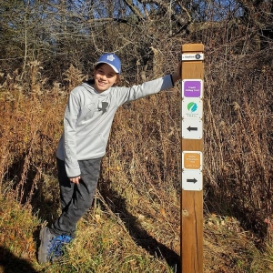 Luke leaning on sign post